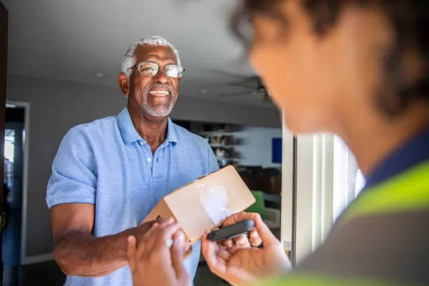 Smiling employee handing over a package