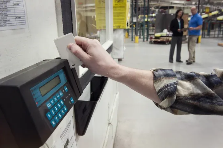 Employee clocking in at a time clock terminal